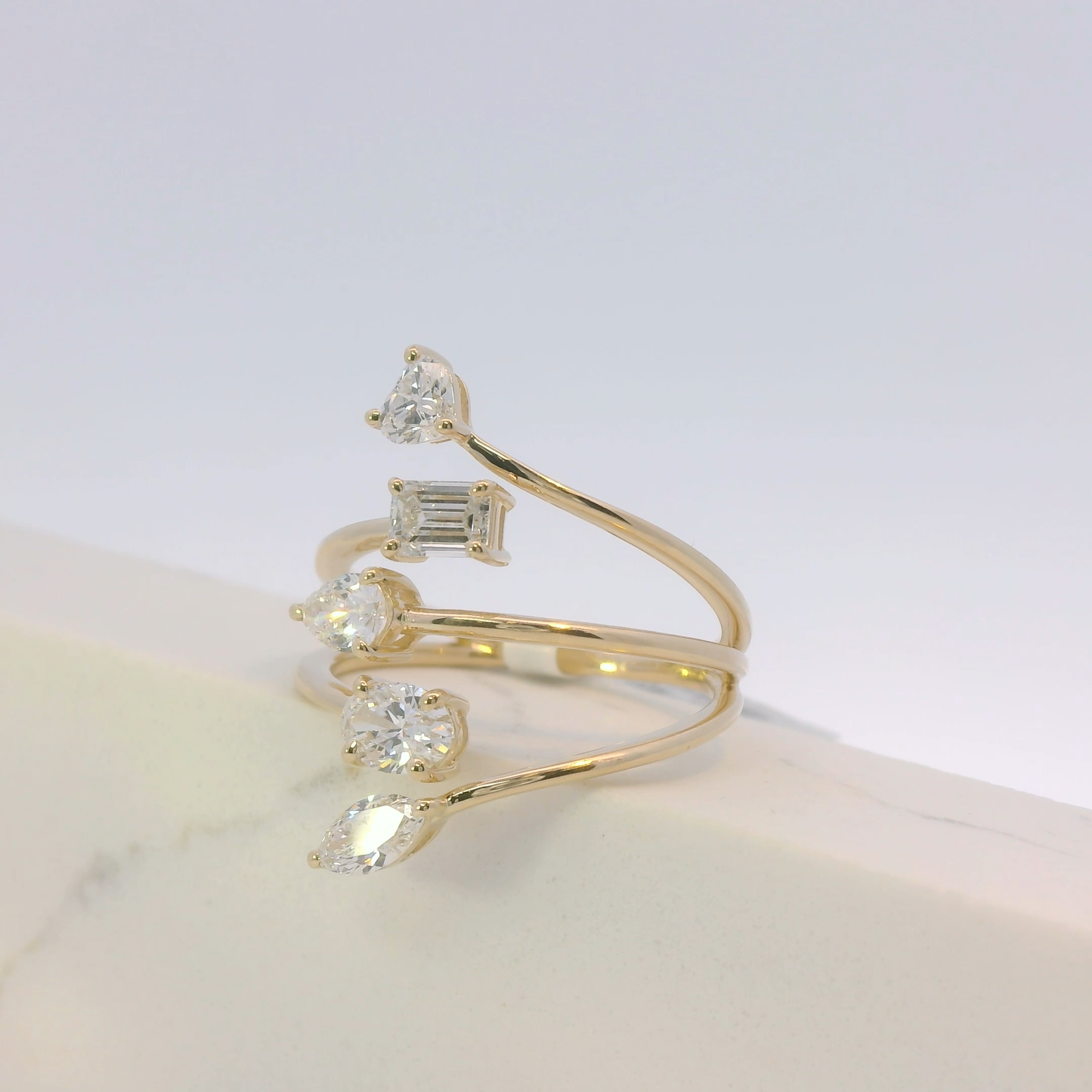 Gold ring with diamond stones on a light background