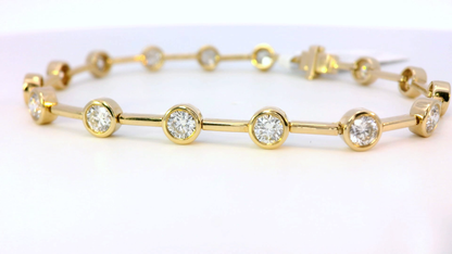Gold bracelet with round ethical lab grown diamonds on a white background