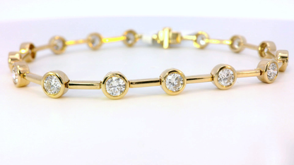Gold bracelet with embedded diamonds on a white background
