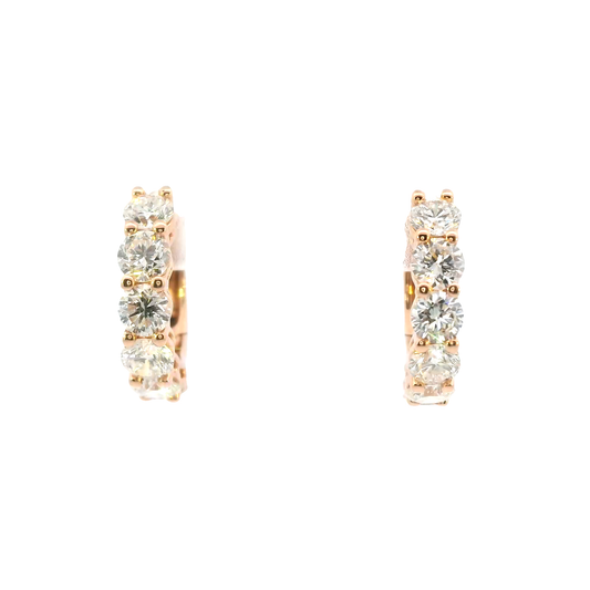 Rose gold hoop earrings with clear gemstones on a white background