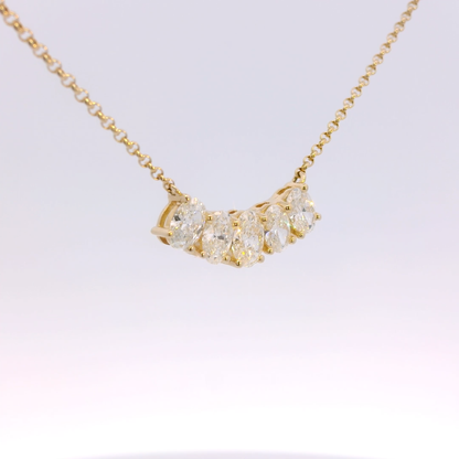 Gold necklace with diamond pendants on a white background