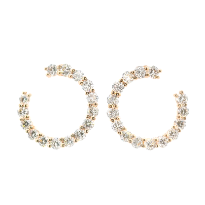 Pair of gold and silver hoop earrings on a white background