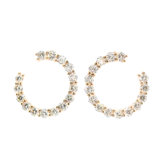 Pair of gold and silver hoop earrings on a white background