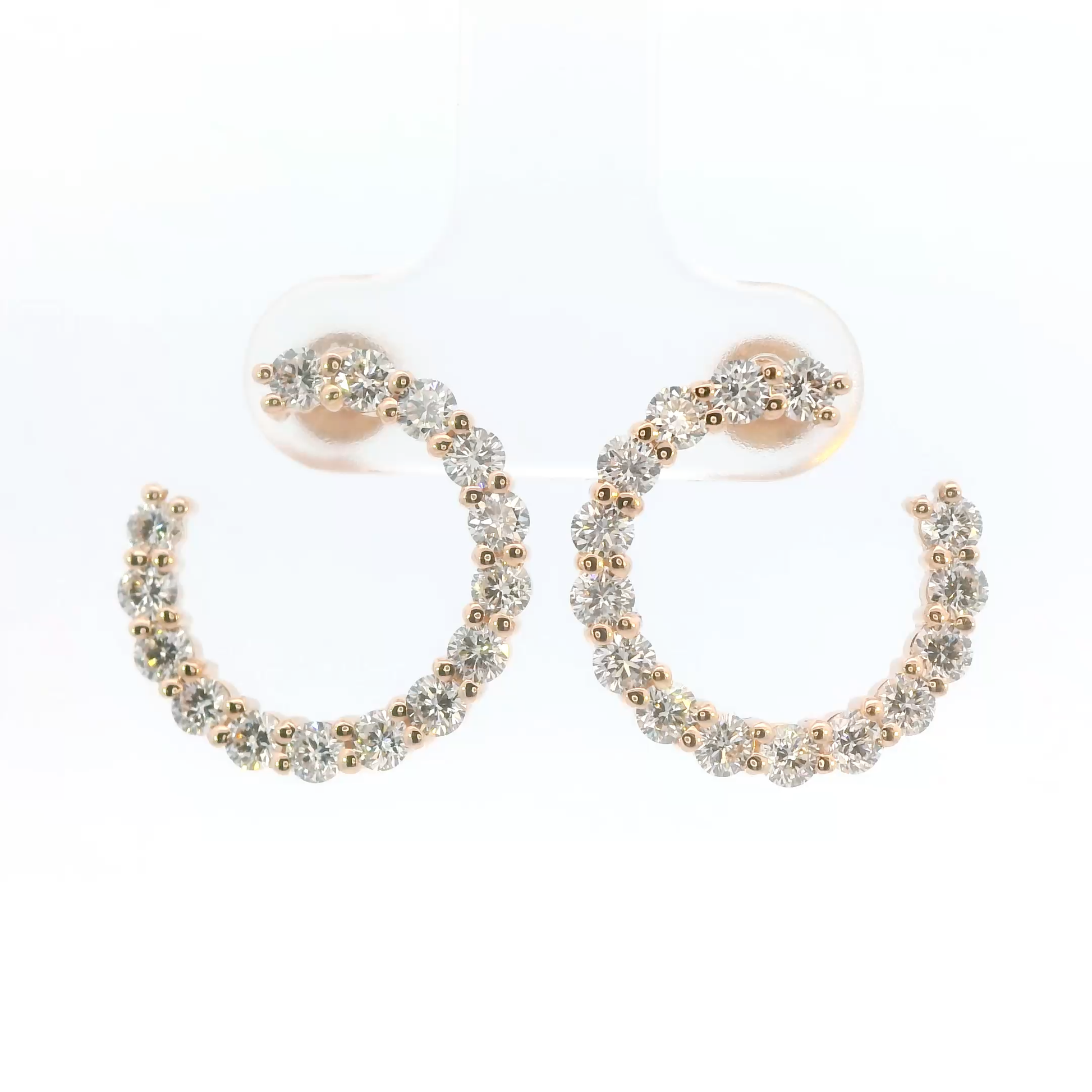 Pair of hoop earrings with gold and clear bead detailing on a white background