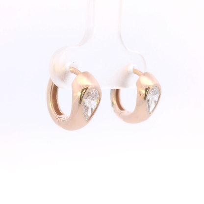 Pair of gold hoop earrings with clear gemstones on a white background