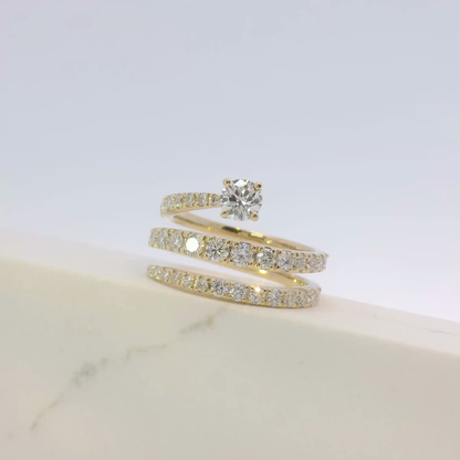 Gold ring with diamond on a light gray background