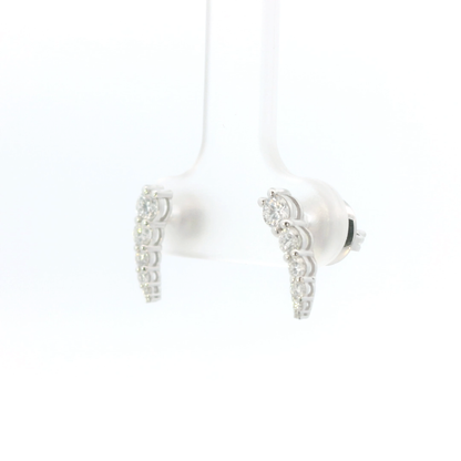 Pair of white earbuds with silver accents on a white background