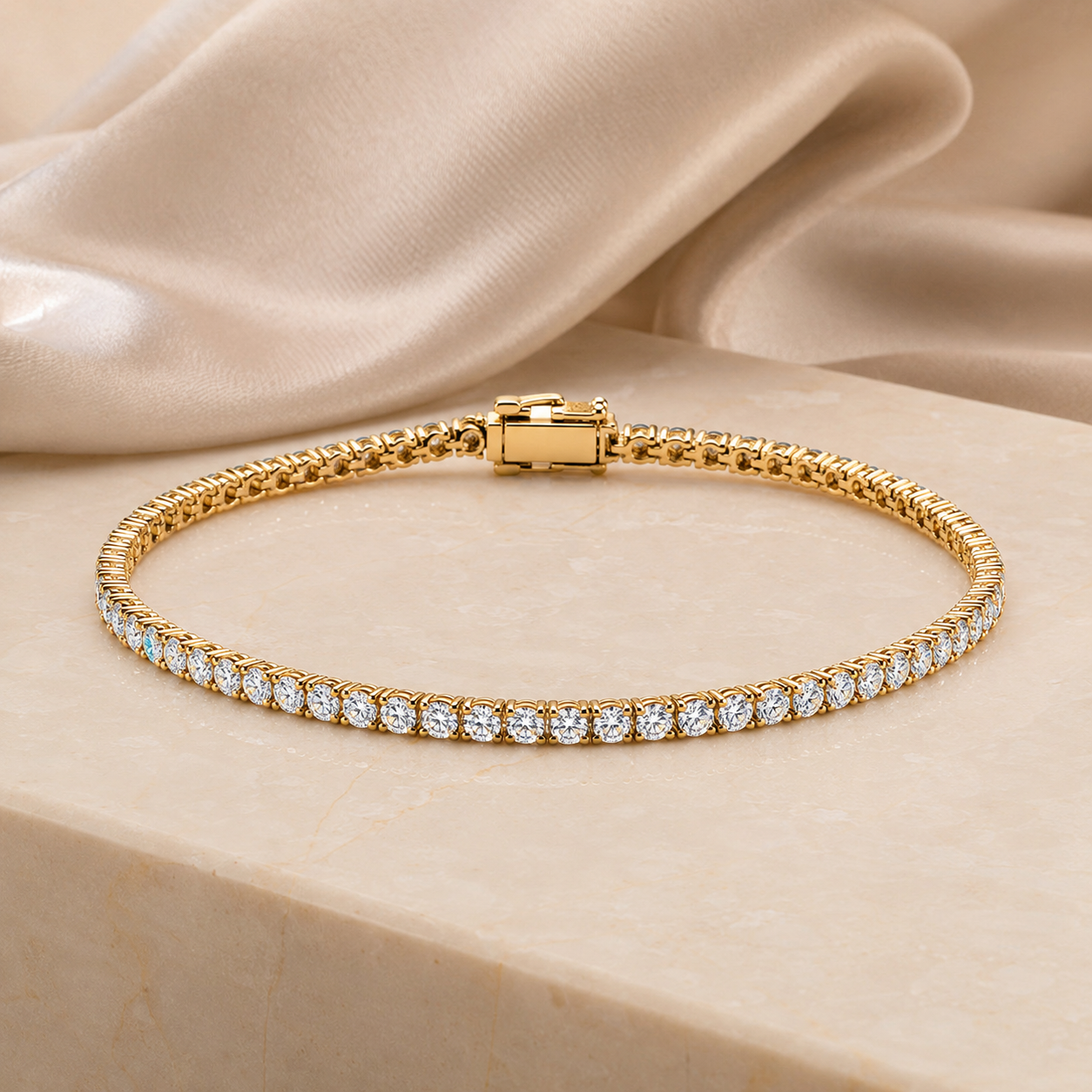Isaline Fine Line 9k yellow gold lab grown diamond tennis bracelet on an ivory stone surface