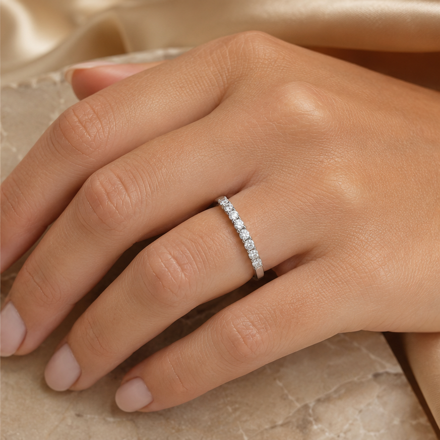 Nerisse 9k white gold round diamond half eternity ring worn on hand