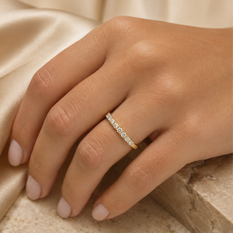Nerisse 9k yellow gold round diamond half eternity ring worn on hand