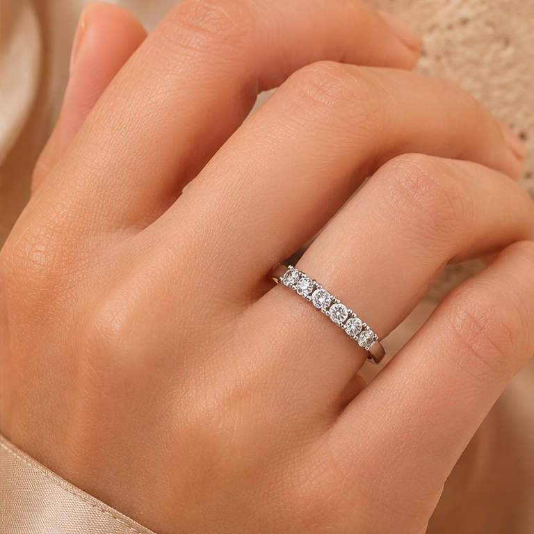 Ottilie 18k white gold round diamond half eternity ring worn on hand