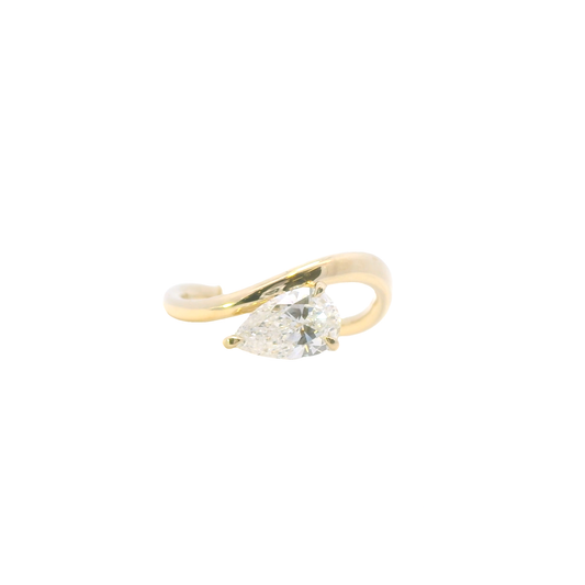 Gold ring with a clear gemstone on a white background