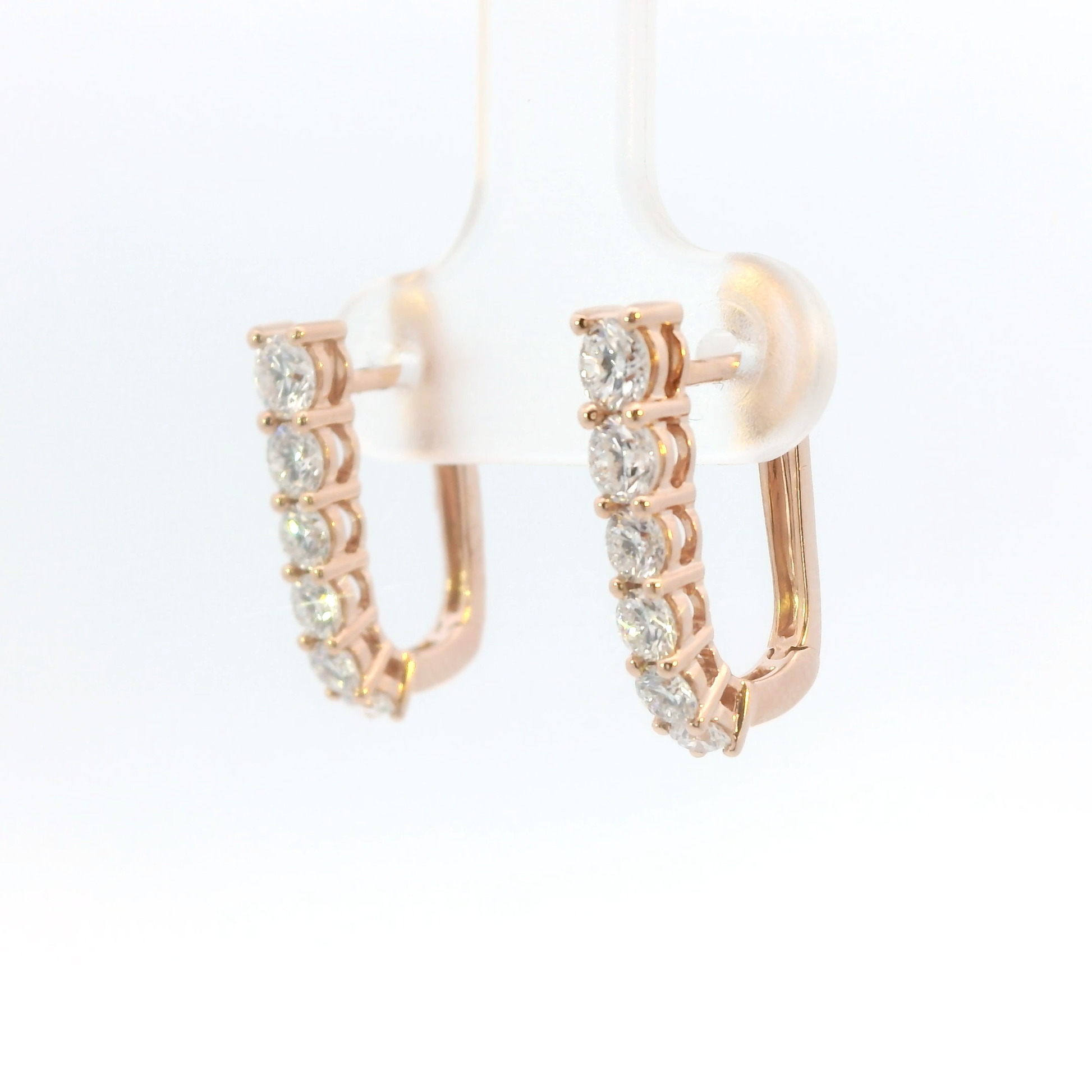 Rose gold hoop earrings with diamonds on a white background