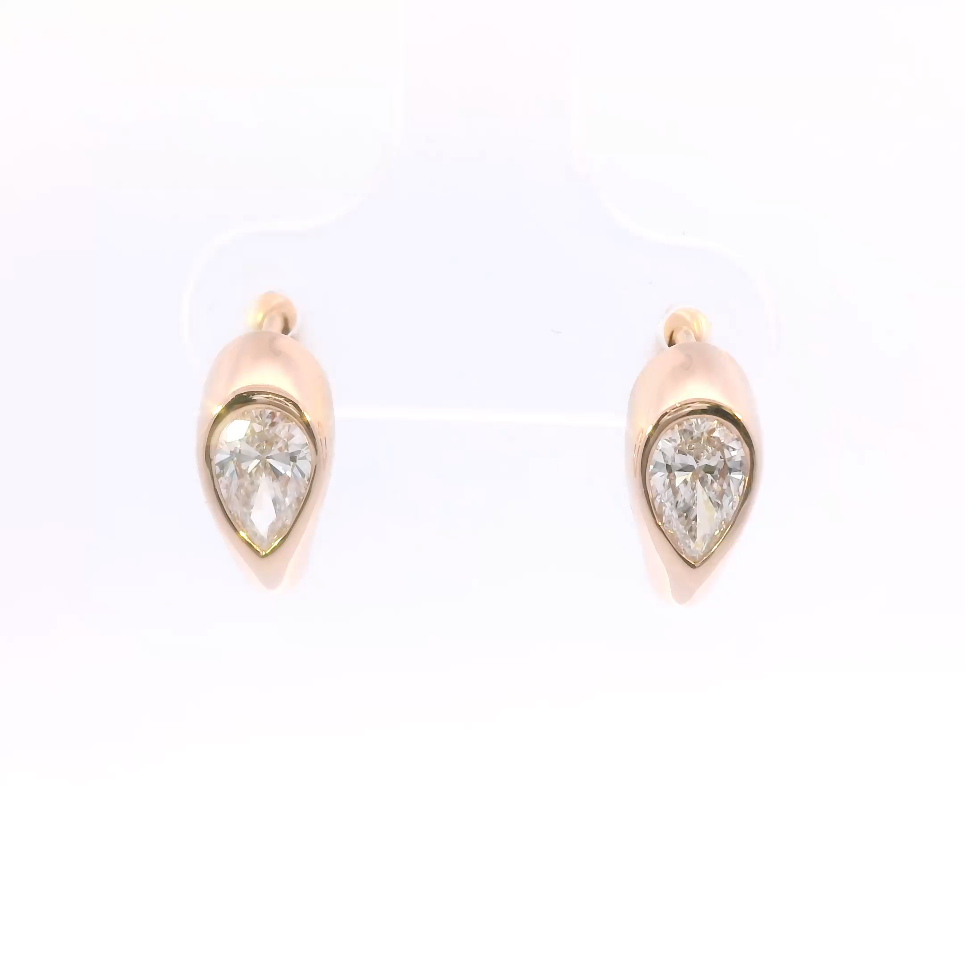 Pair of rose gold earrings with diamonds on a white background