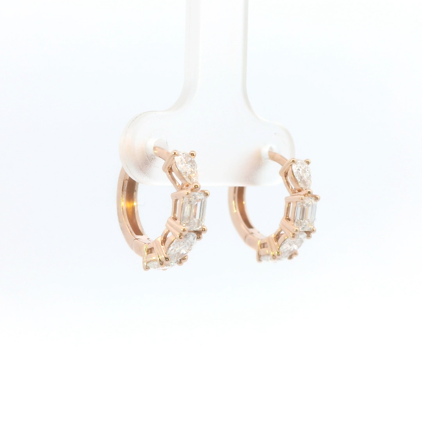 Rose gold hoop earrings with diamond accents on a white background