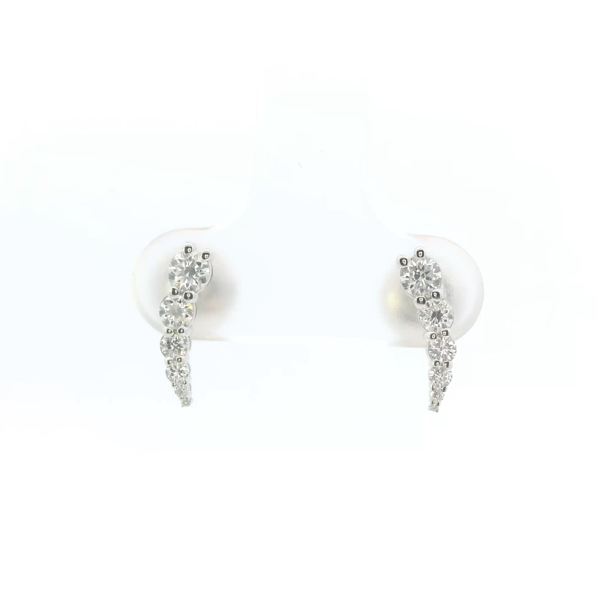 Pair of silver earrings with clear stones on a white background